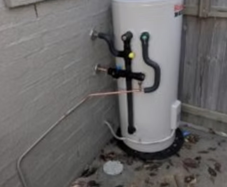 Electric hot water system installed against a brick wall